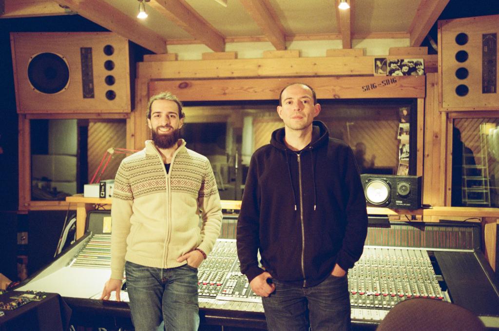 Novak and Juan standing in front of the SSL mixing desk.